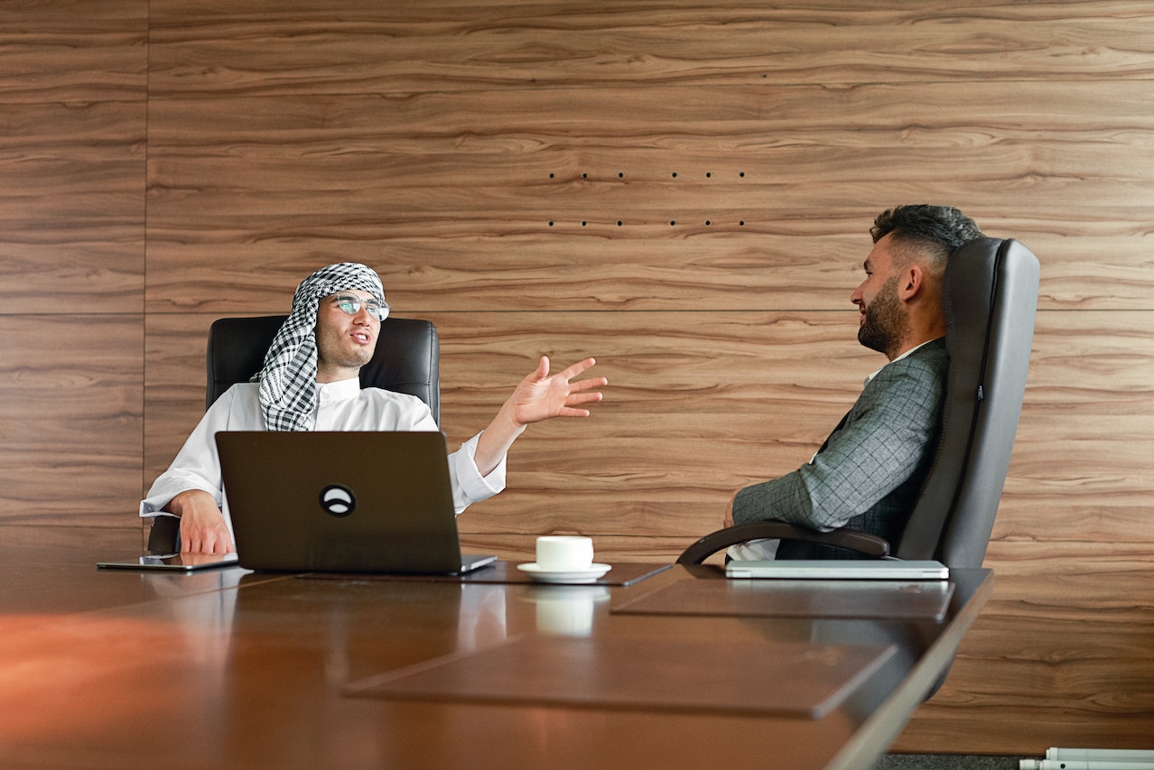 Two Men Talking In A Boardroom