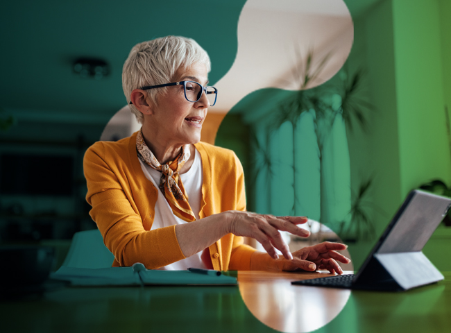 middle aged woman working on a 2-in-1 microsoft surface device