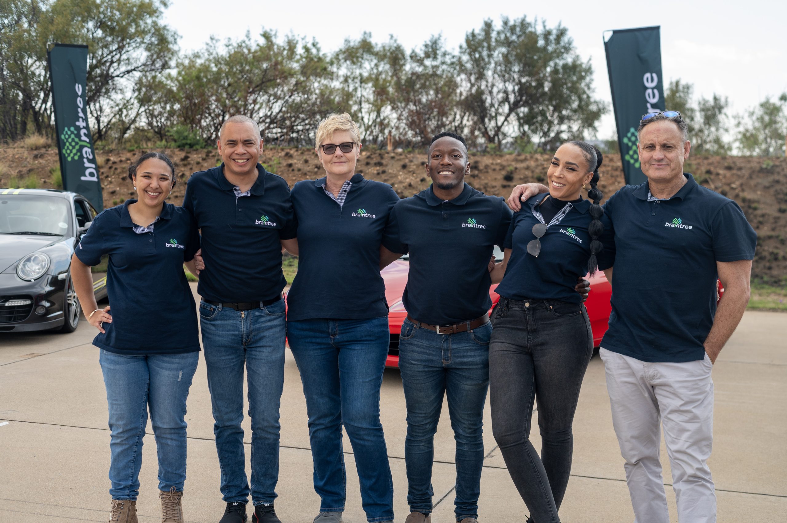 Braintree employees standing in front of supercars - 2