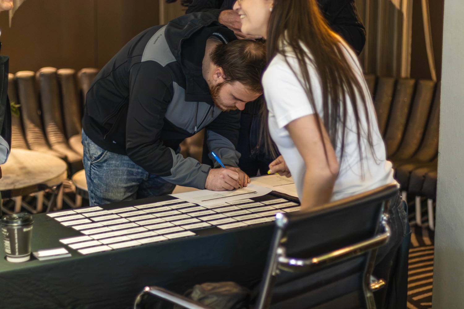 A guest signing in at the welcome desk on arrival
