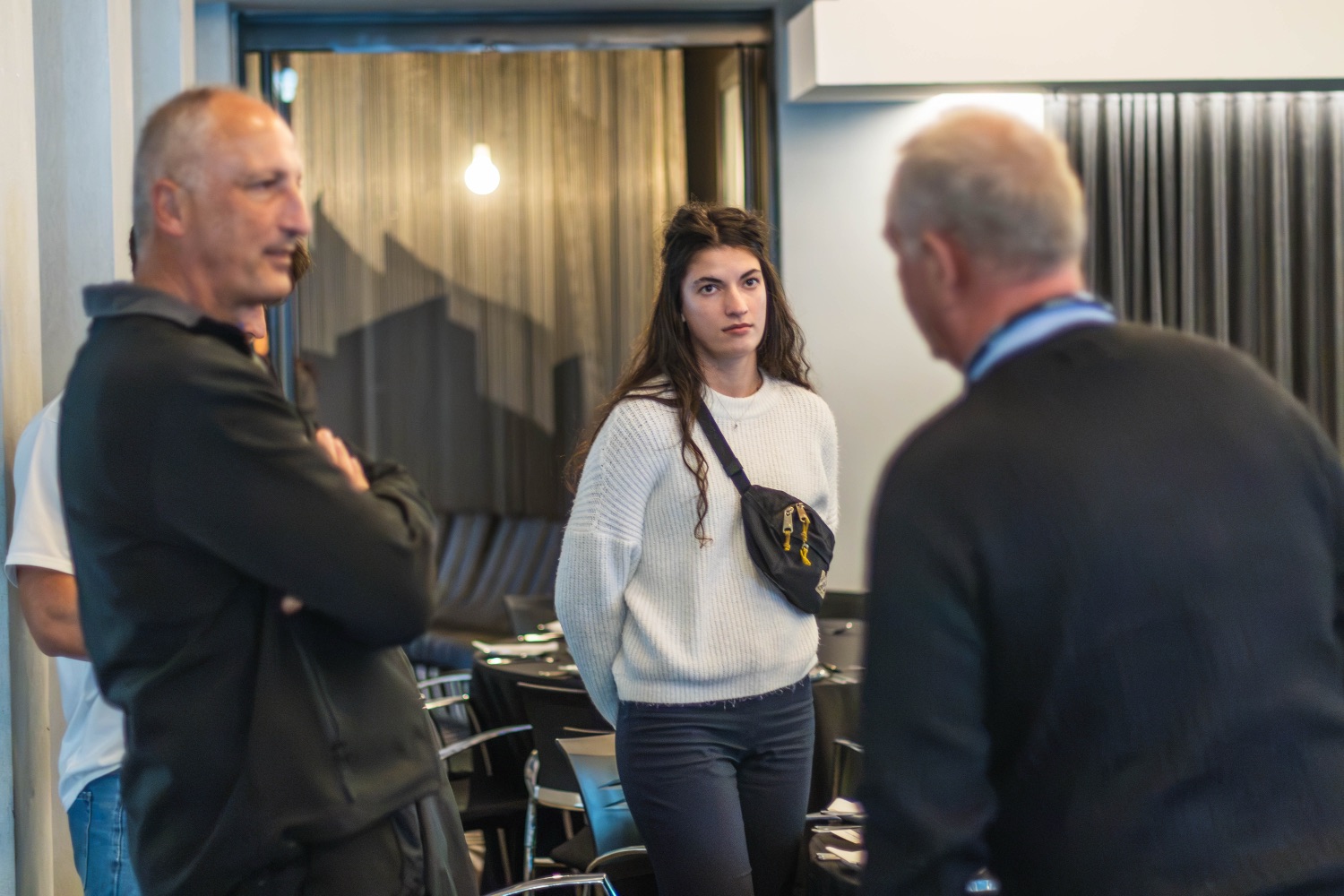 Three guests in conversation during arrival
