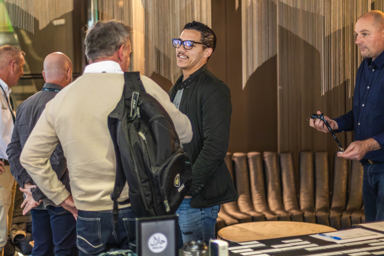 Guests share a laugh while networking before the session
