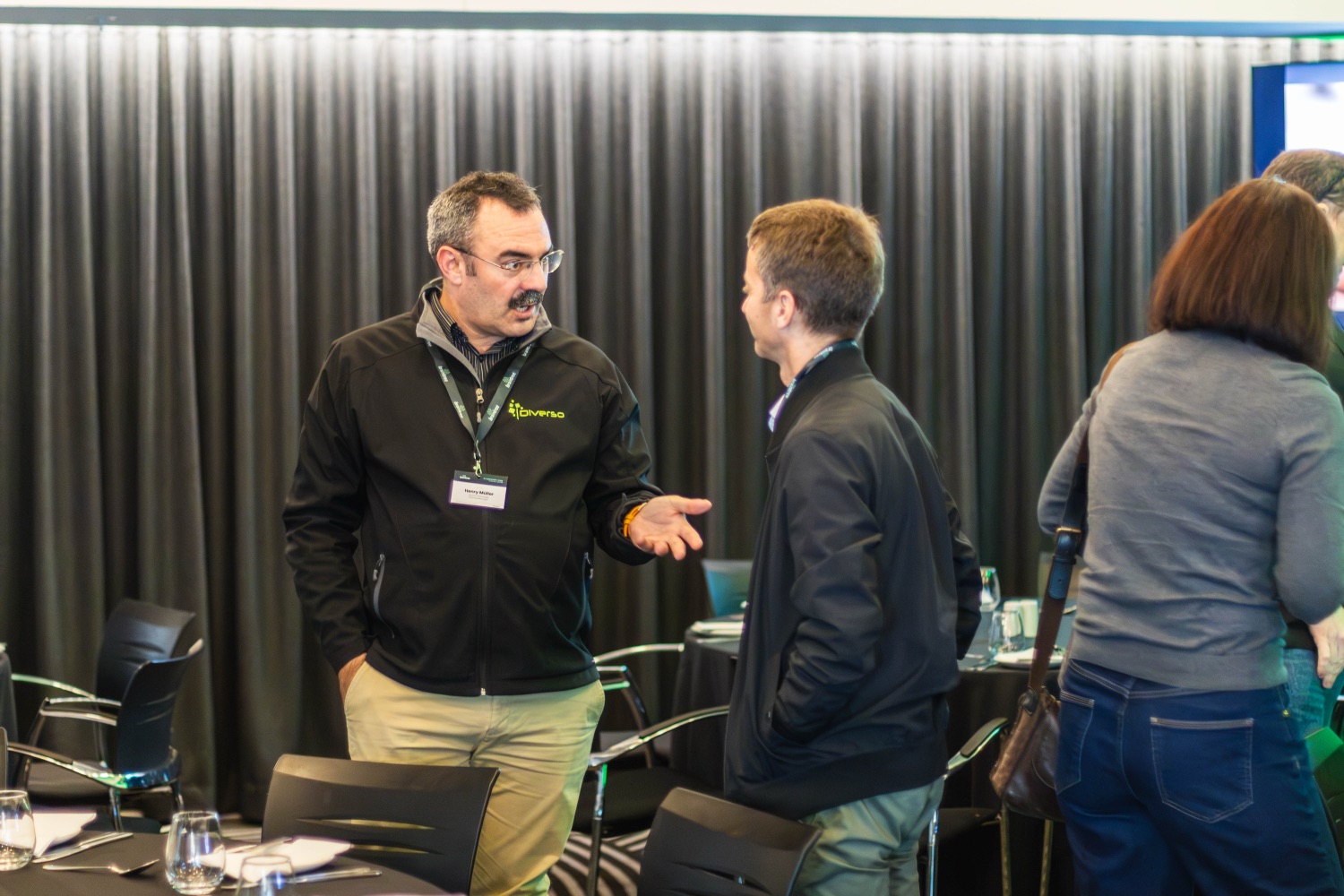 A host in conversation with guests in the session room