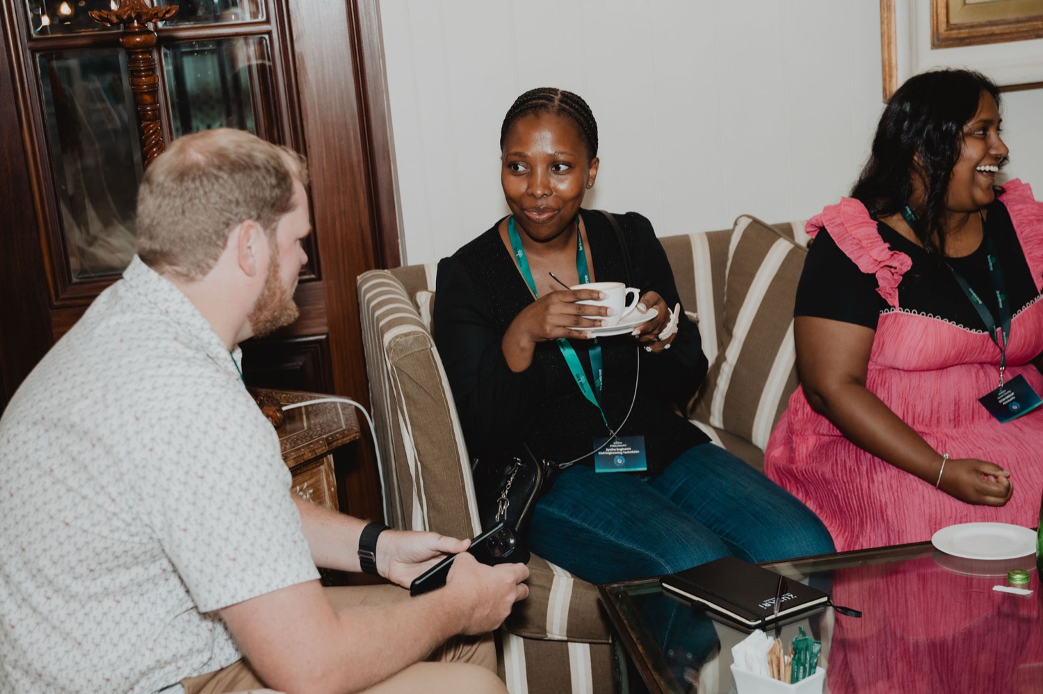 Guests laughing together over coffee