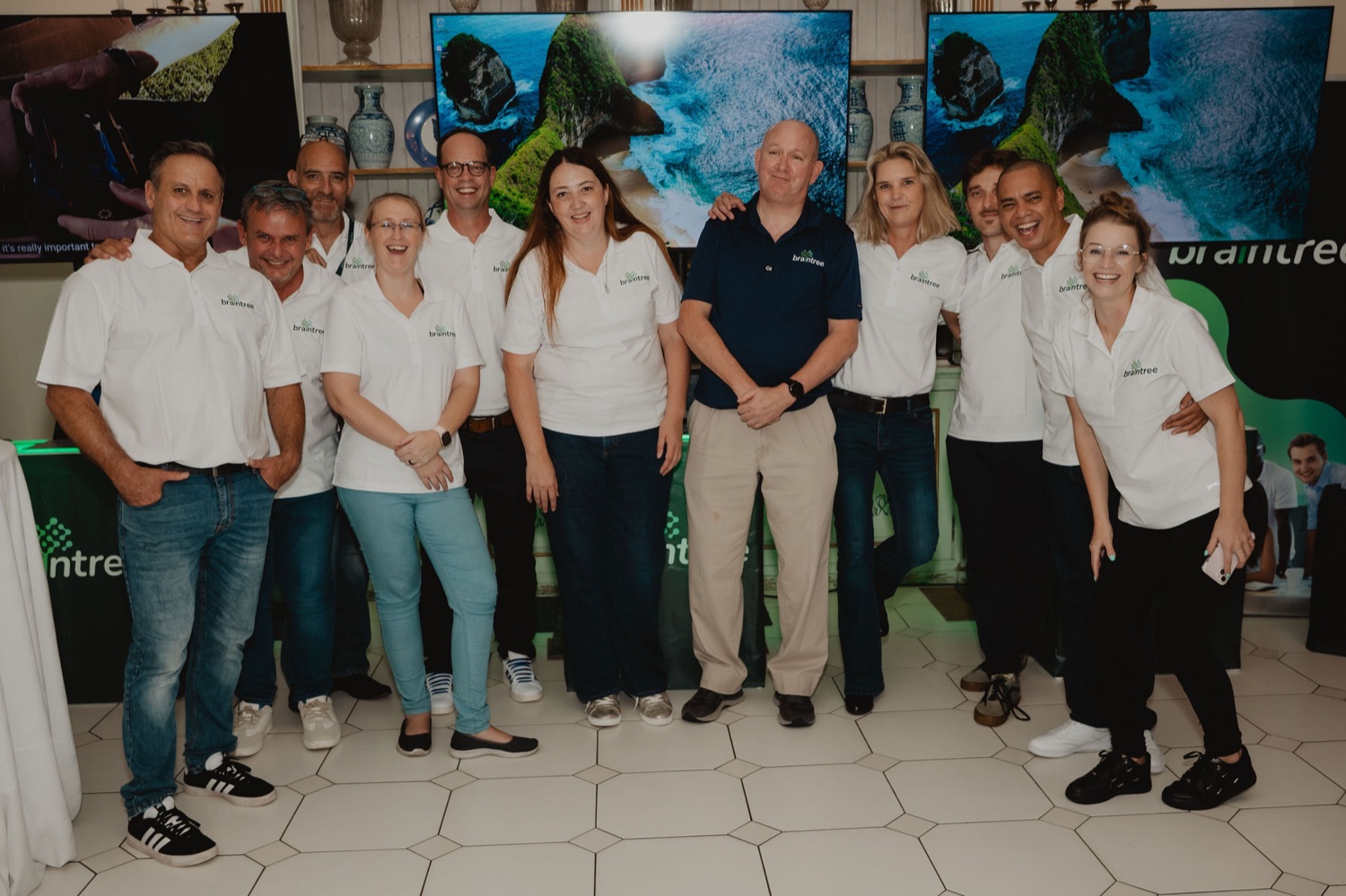 The Braintree team together by the event banners