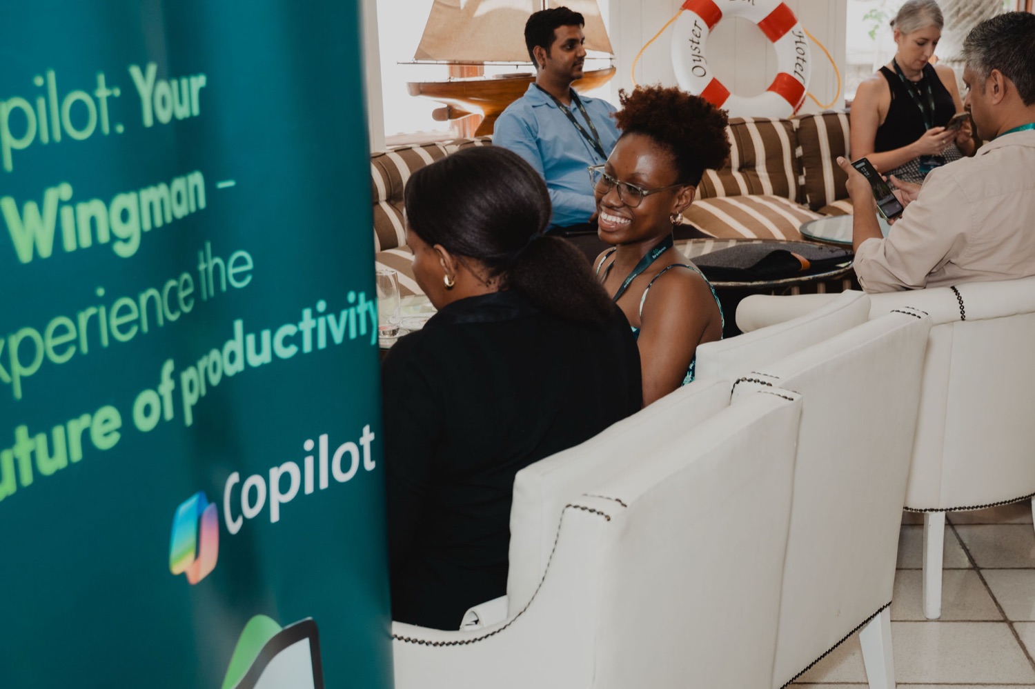 A guest smiling beside the Copilot productivity banner