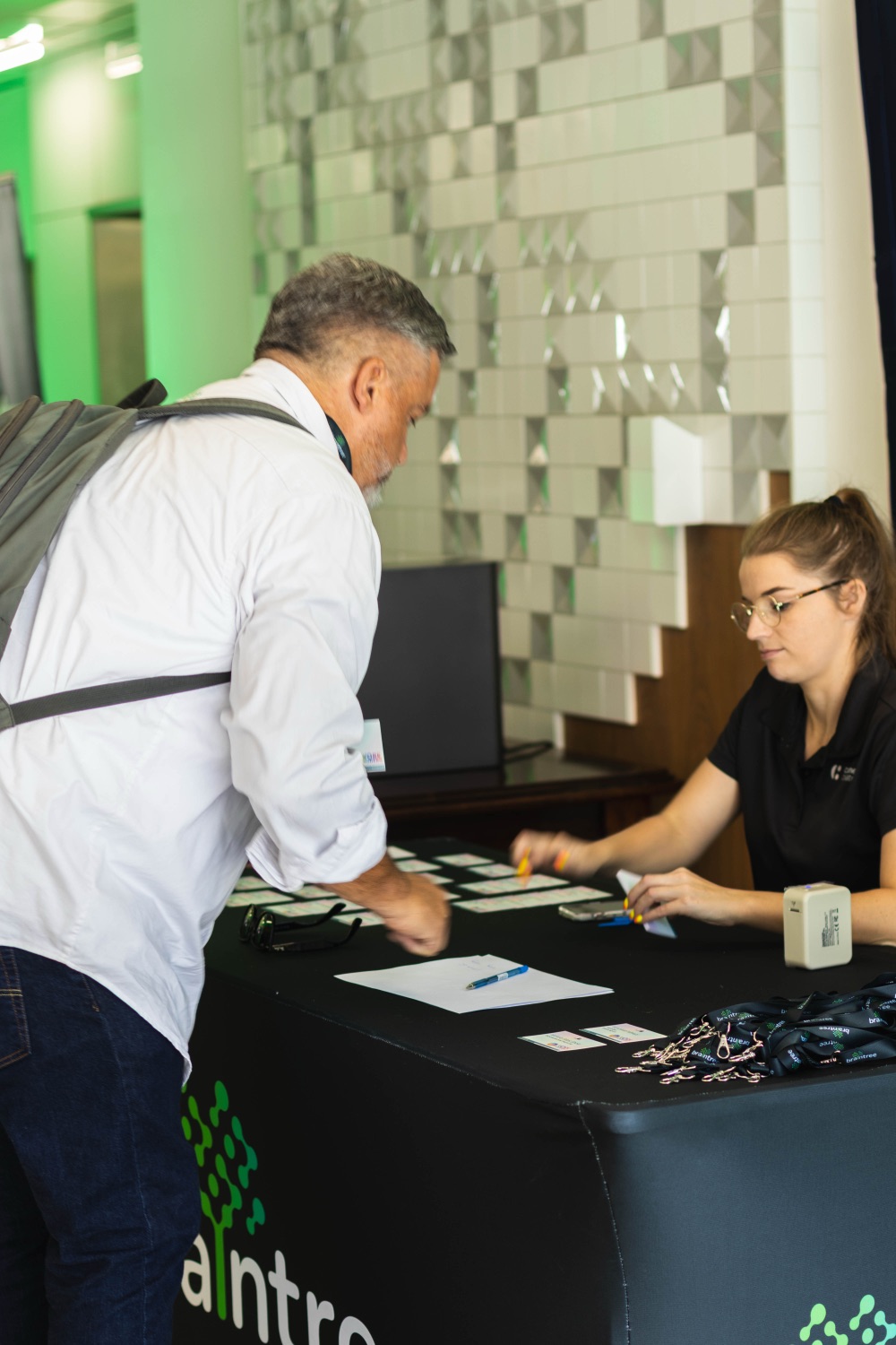 A guest checking in with a host at the registration desk
