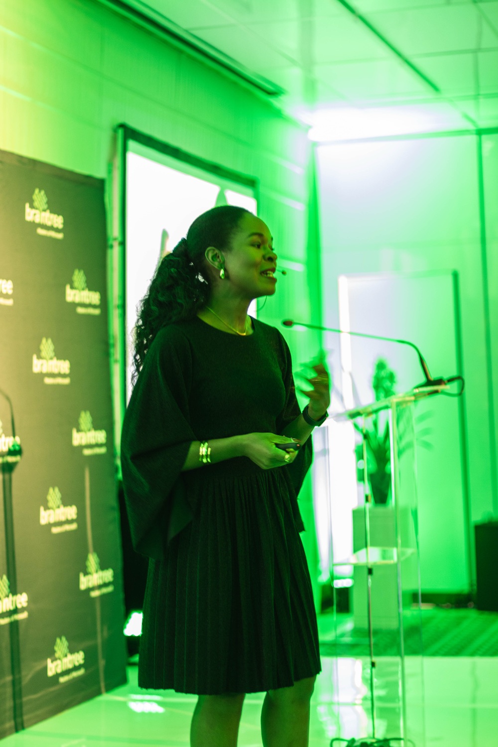 A speaker addressing the room from the stage