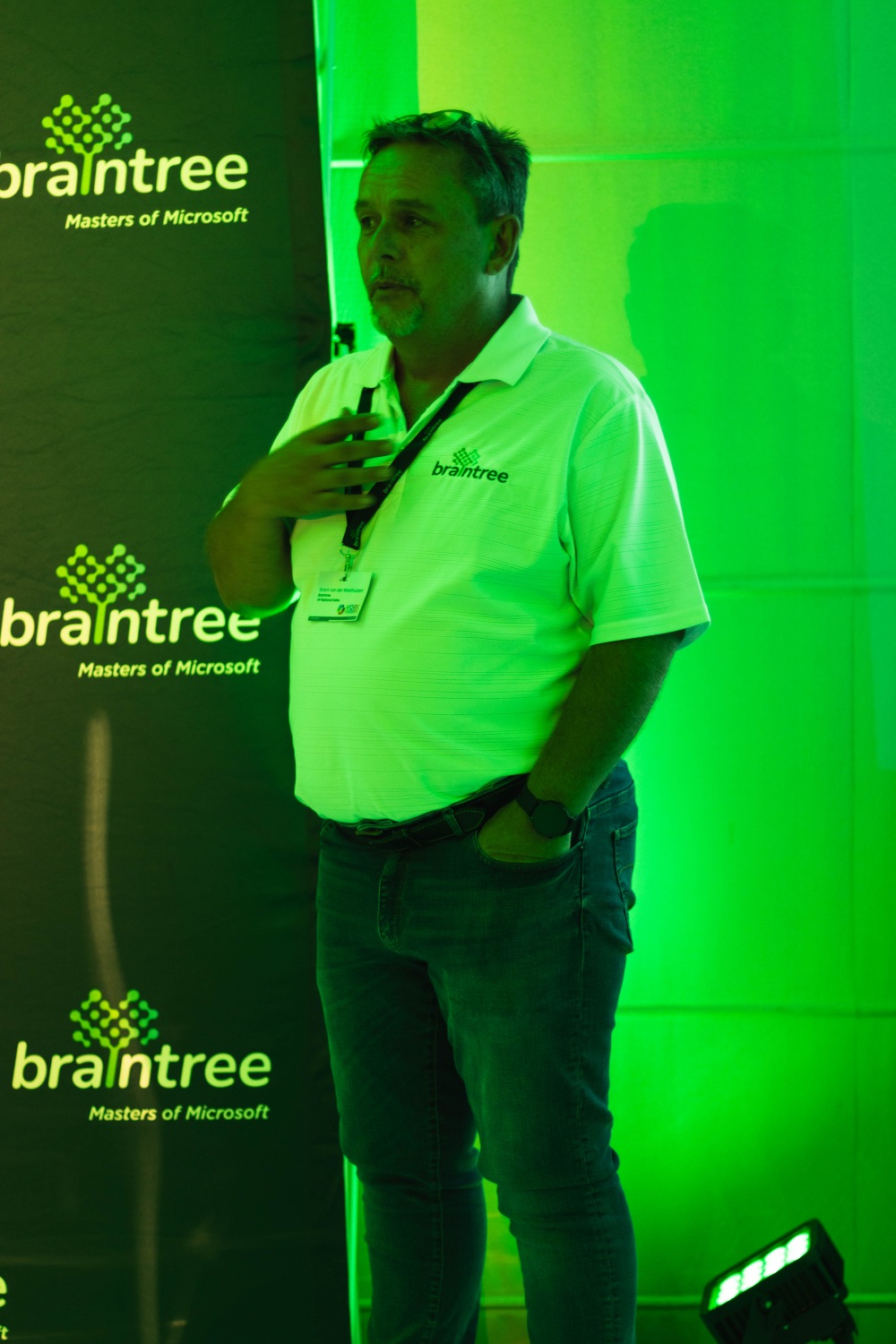 A speaker addressing the room in front of the Braintree backdrop