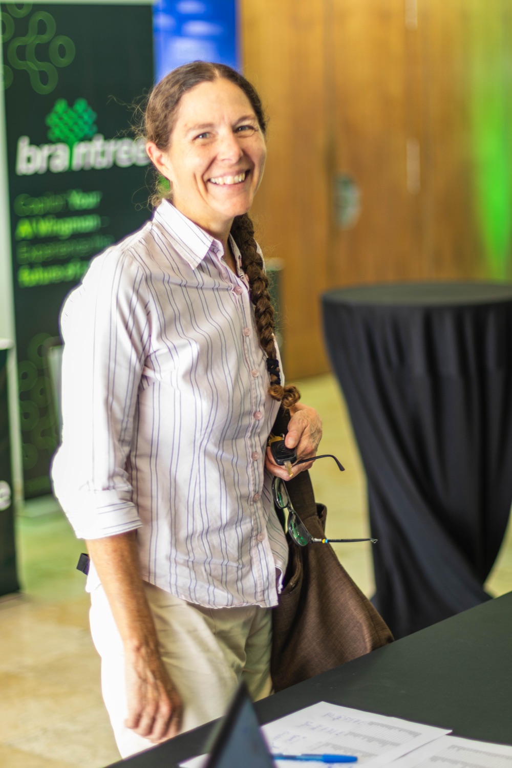 A guest smiling beside the Braintree backdrop