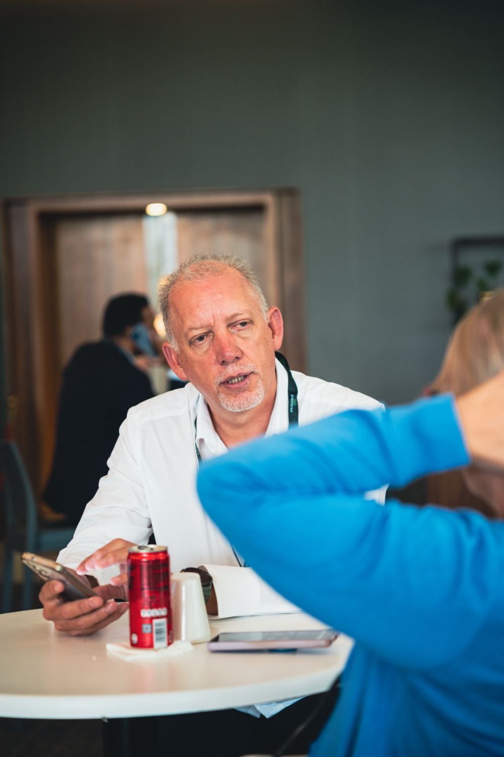 A guest chatting animatedly at a table during a break