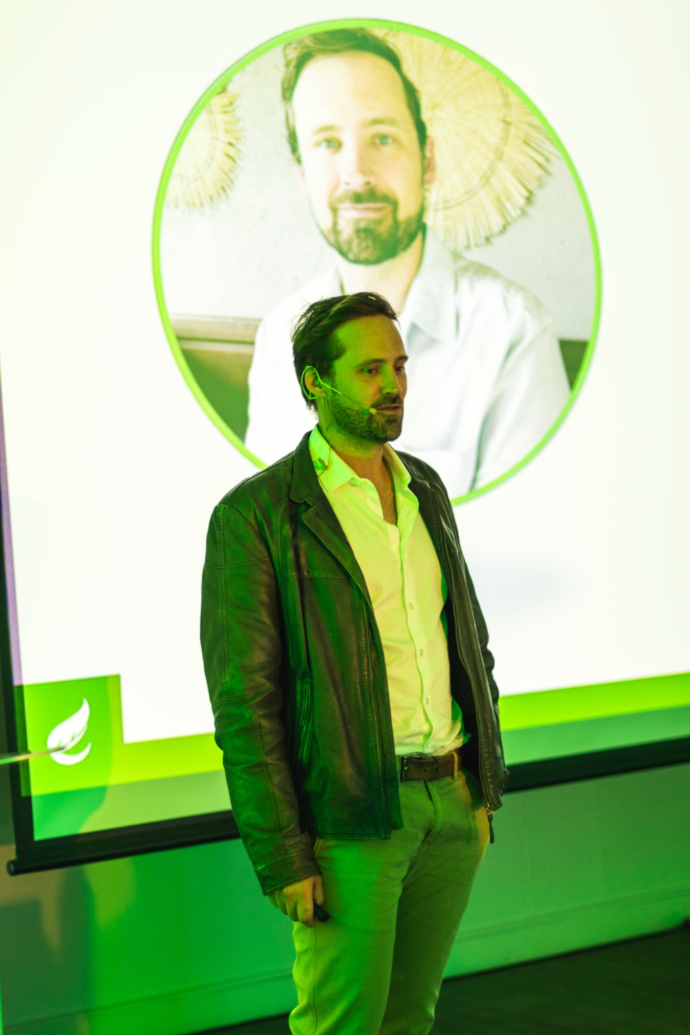 A speaker presents in front of the Matumi portrait slide