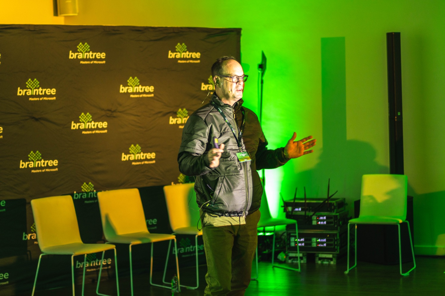 A speaker presenting in front of the braintree branded backdrop